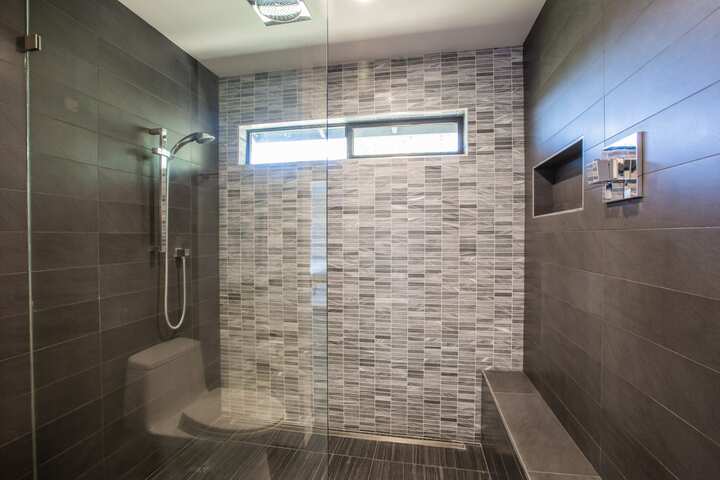 Gorgeous walk-in shower installation with dark tile for Yuba City, California home